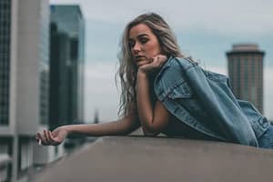 Anxious woman smoking a cigarette on a rooftop