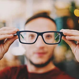 blurry male face seen through extended eye glasses