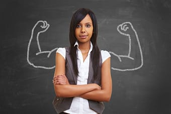 Fearless young woman standing in front of muscle drawing