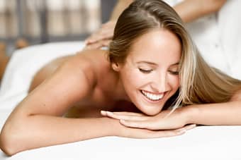 Smiling woman receiving back massage