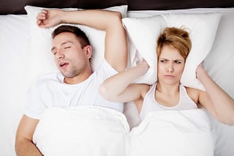 Woman being kept awake by snoring partner