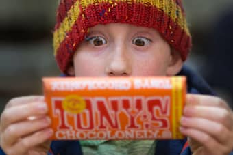 Boy looking with amazement at huge chocolate bar