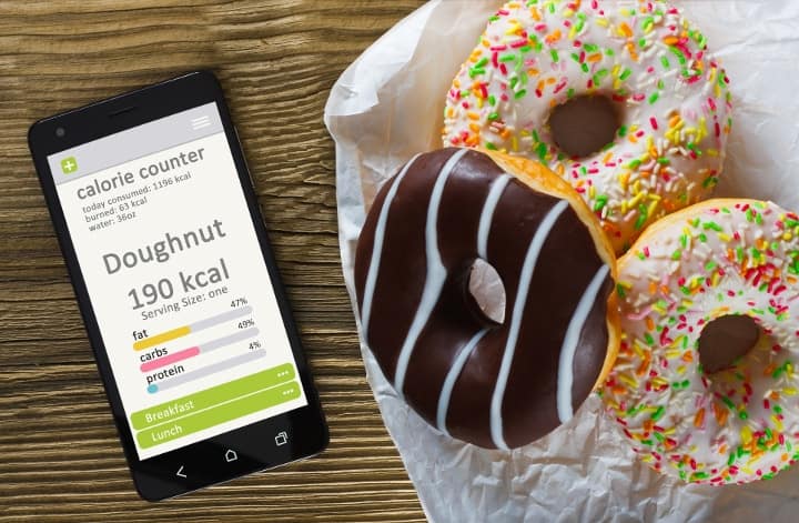 phone app for counting calories next to donuts