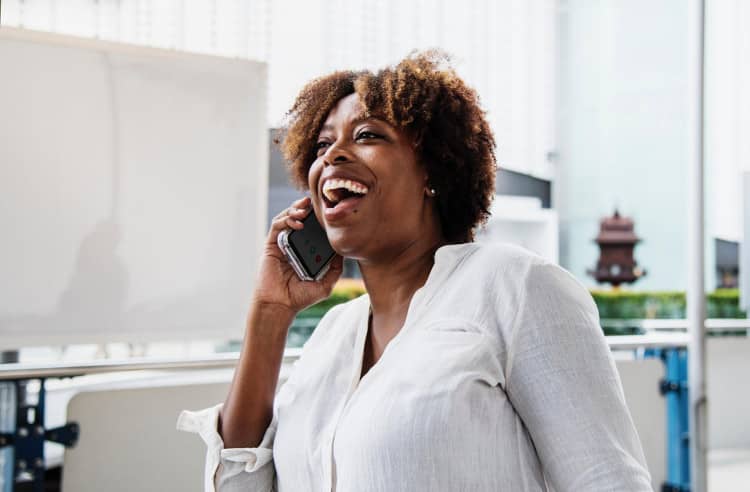 Happy woman speaking on a cell phone