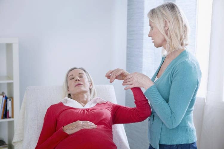therapist taking woman into state of hypnosis