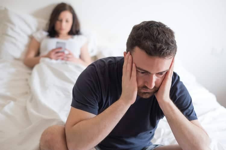 Couple having trouble going to sleep due to stress