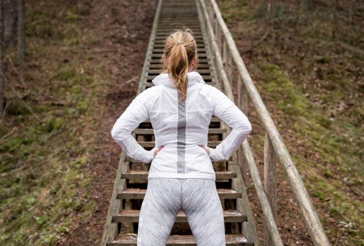 Determined female athlete in front of stairs