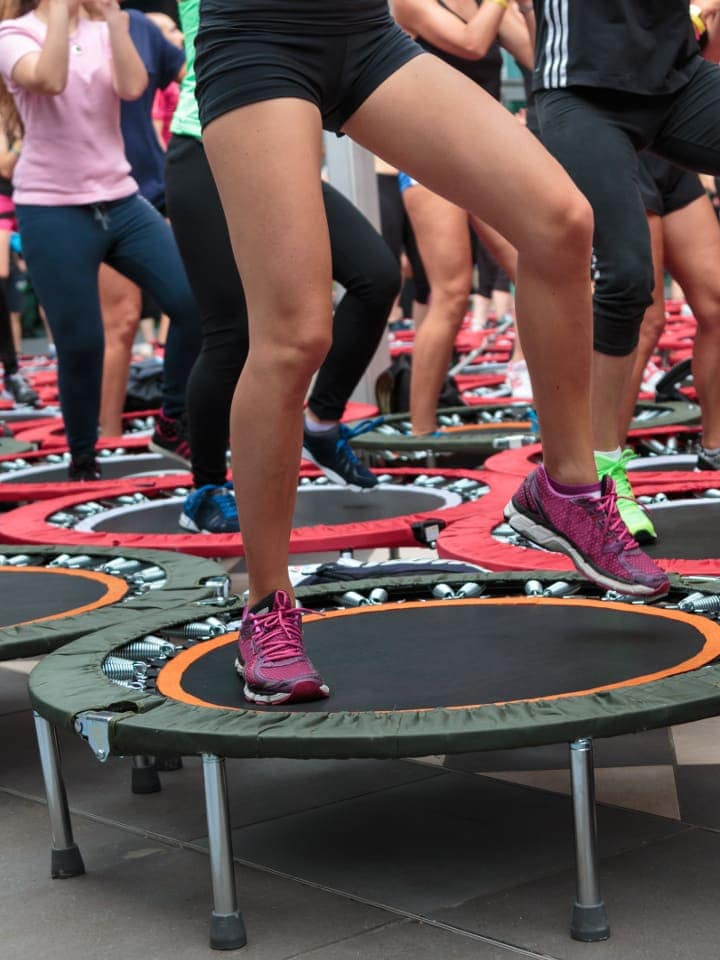 Women exercising on rebounders in fitness class