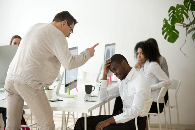 black man being scolded by boss